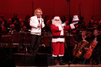 Maestro Kirk Muspratt celebrates the Symphony’s 75th birthday with Santa.