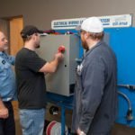 William Kennedy, Tim Garlack and James Peterson perform wiring tests during an 18-week course designed and developed by Ivy Tech educators.