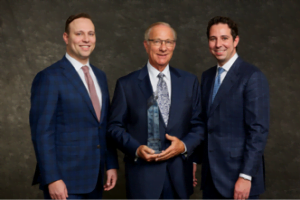 Dean Rothschild, center, with his sons Adam, left, and Rob, of Rothschild Agency Inc.